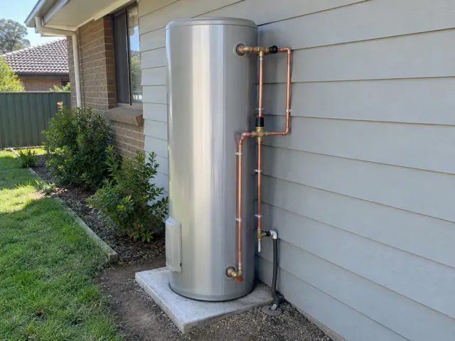 Newly installed outdoor hot water system beside a weatherboard house in Gateshead